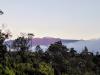 Snow-capped Mauna Kea glowing red during sunrise